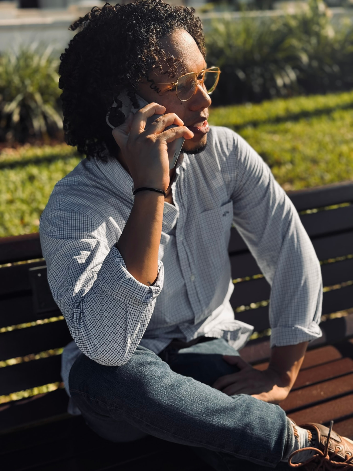Julio Mata taking a call on a park bench